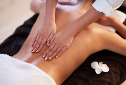 Relaxed smiling woman receiving a back massage in a spa